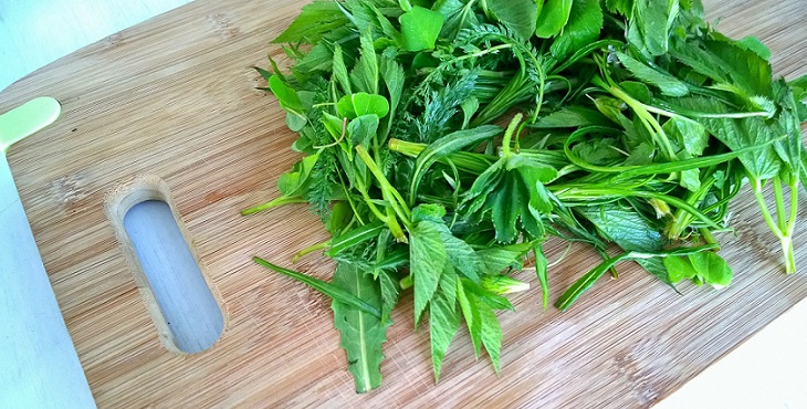 Image of a variety of greens on a cutting board. Cooking With Greens