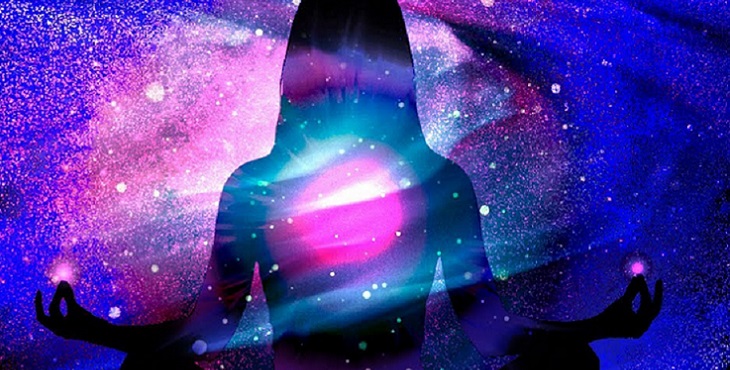 Image of a silhouette sitting in meditation in the galaxy among the bright stars.