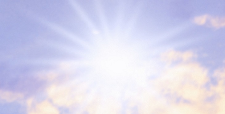 Image of the lustrous Sun shining above the lavender sky in the background.
