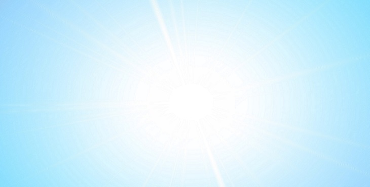 Image of the beaming Sun with a soft light blue sky in the background.